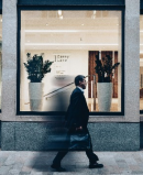 Man Walking on Sidewalk